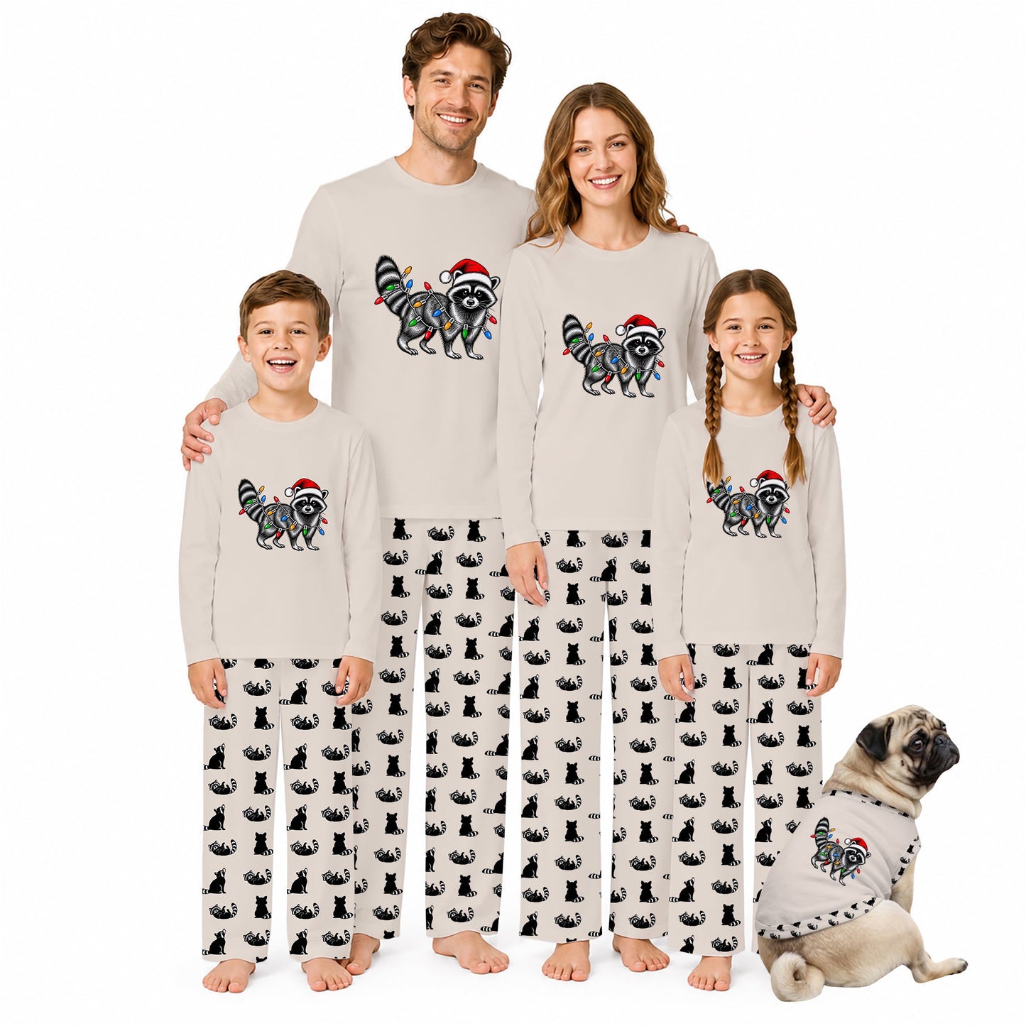 A family of four wearing matching Christmas-themed pajamas stands together on a white background, with a small dog sitting at their right. The pajamas are light beige long-sleeve tops with a colorful raccoon graphic wearing a Santa hat, paired with black-and-white cat-print pants.