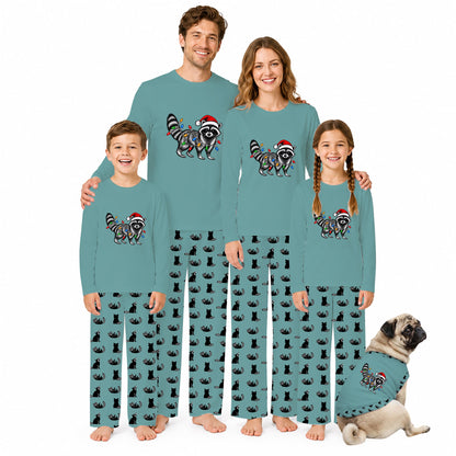A family of four and a dog wearing matching teal long-sleeve pajamas with a raccoon and Santa hat graphic on the chest, photographed against a plain white background.