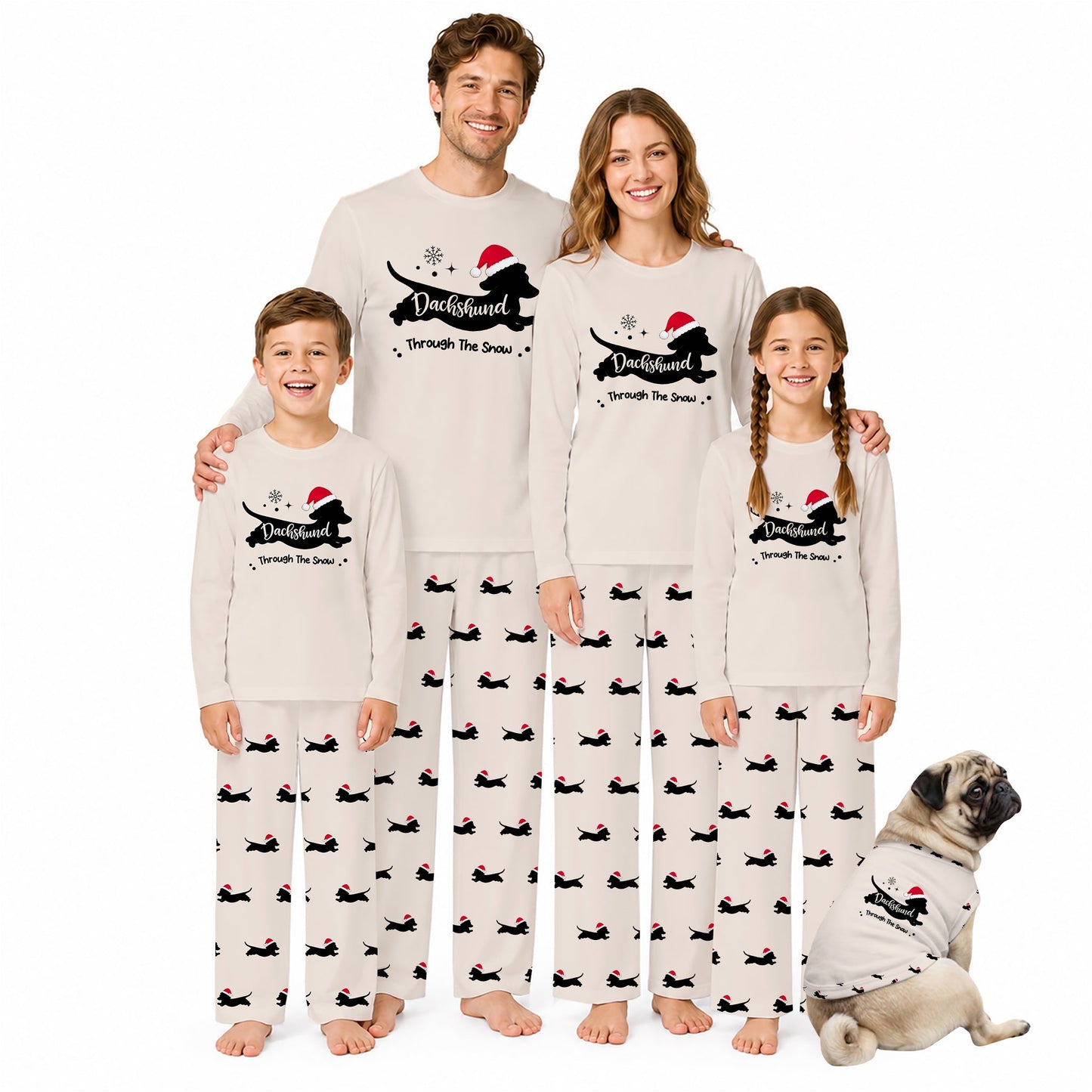 A family of four and a dog wearing matching holiday-themed long-sleeve pajamas with a Black silhouette graphic, Red Santa hat, and 'Through the Snow' text, posed against a plain White background.