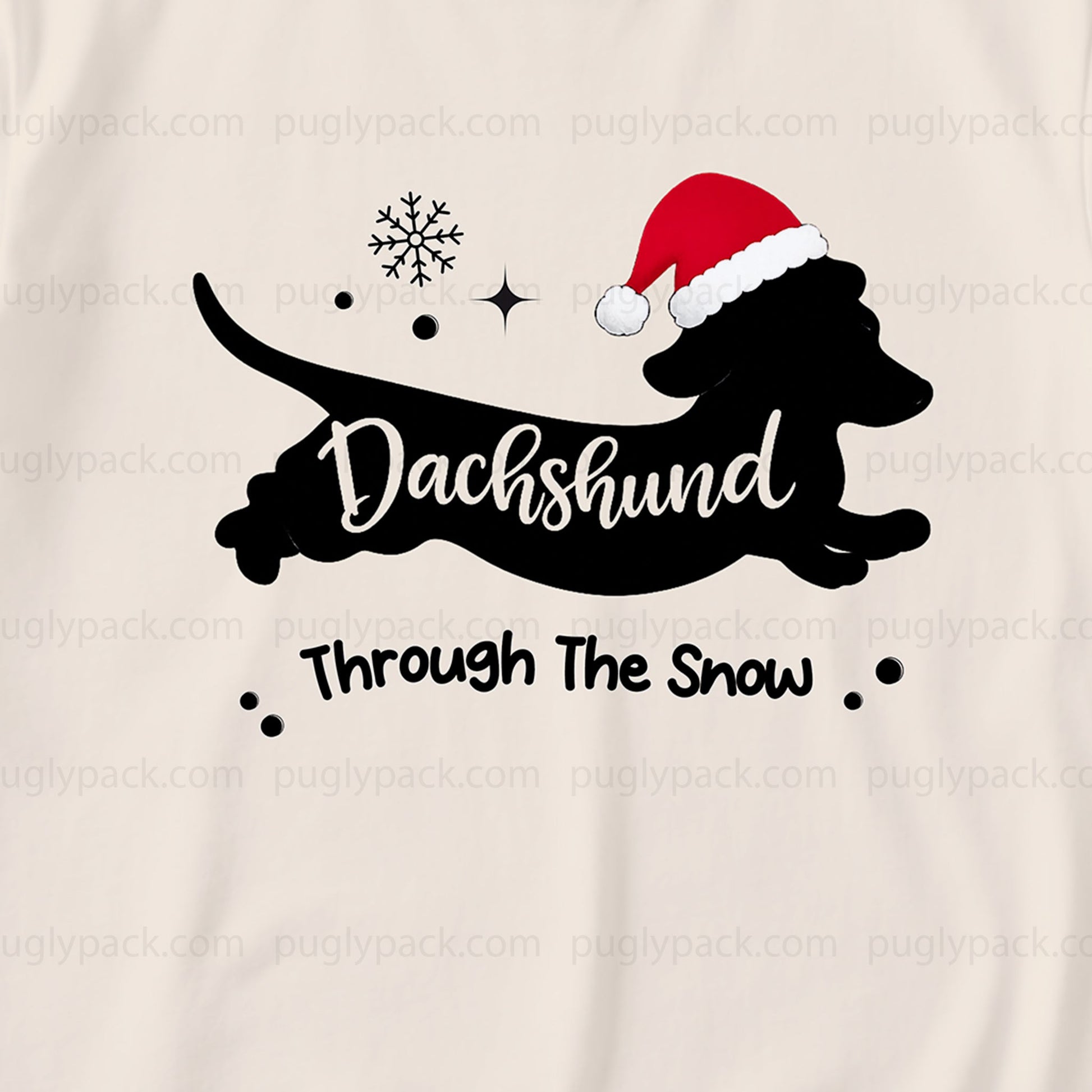 A close-up of a Cream-coloRed garment featuring a Black graphic of a dachshund wearing a Red Santa hat, with the text 'Dachshund Through The Snow' and small snowflake and star accents.
