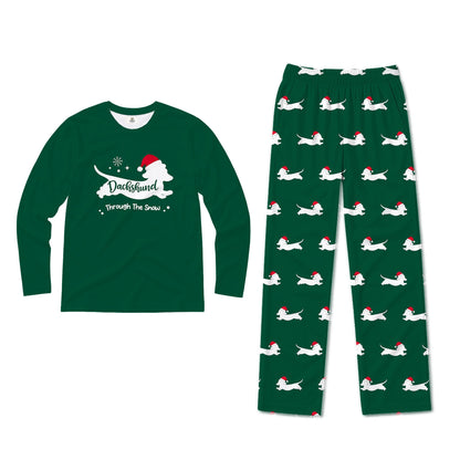 A two-piece Christmas-themed pajama set featuring a dark Green long-sleeve shirt with a White dog silhouette and the text 'DuckHunter Through The Snow' with a Santa hat, and matching dark Green pants with an all-over print of White dogs wearing Red Santa hats.