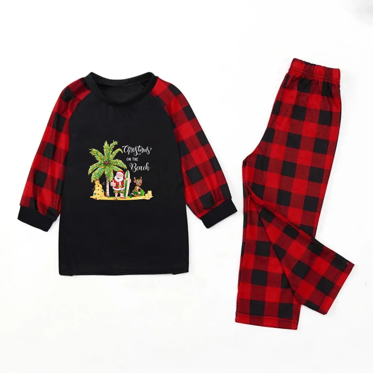 A two-piece children's pajama set laid flat on a White background. The long-sleeve top is Black on the front with Red and Black plaid sleeves and a 'Christmas on the Beach' graphic.