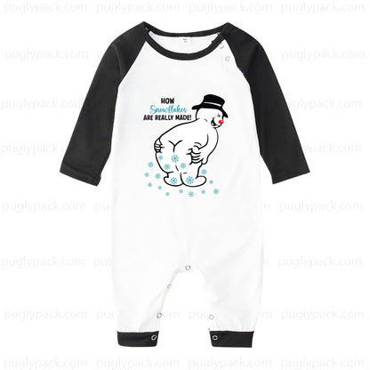 A baby one-piece romper with a White body and Black 3/4 sleeves, featuring a cartoon snowman graphic and the text 'HOW Snowman ARE REALLY MADE!' on the chest.