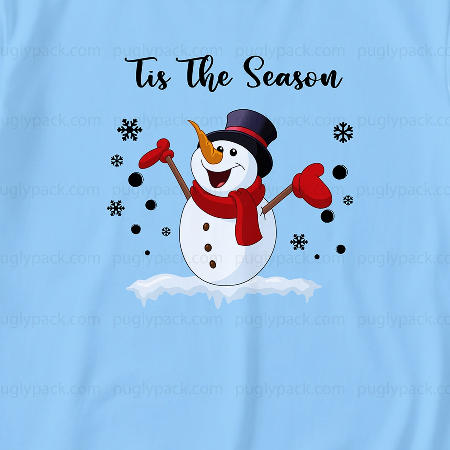 A light Blue t-shirt featuring a festive graphic of a cartoon snowman wearing a Black top hat and Red scarf, with the text 'Tis The Season' above it. The design is watermarked with 'puglypack.