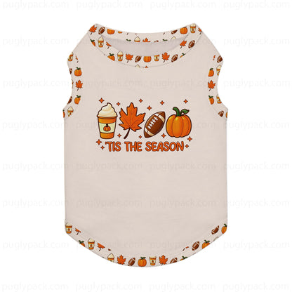 A sleeveless pet shirt in Cream with a festive autumn graphic on the front. The graphic features a coffee cup, maple leaf, football, and pumpkin above the text 'TIS THE SEASON'.